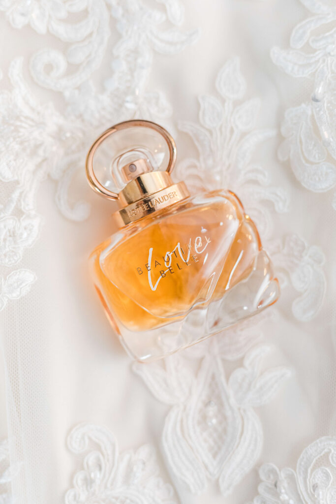 estee lauder perfume on top of wedding dress details photo