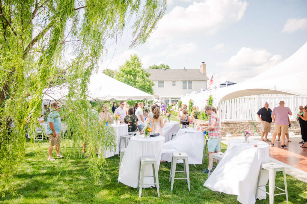 tents, tables, and guests under a willow tree at an ohio outdoor wedding