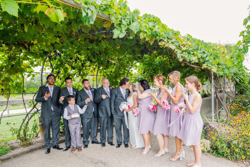 entire bridal party dressed in grey and purple at vinoklet winery
