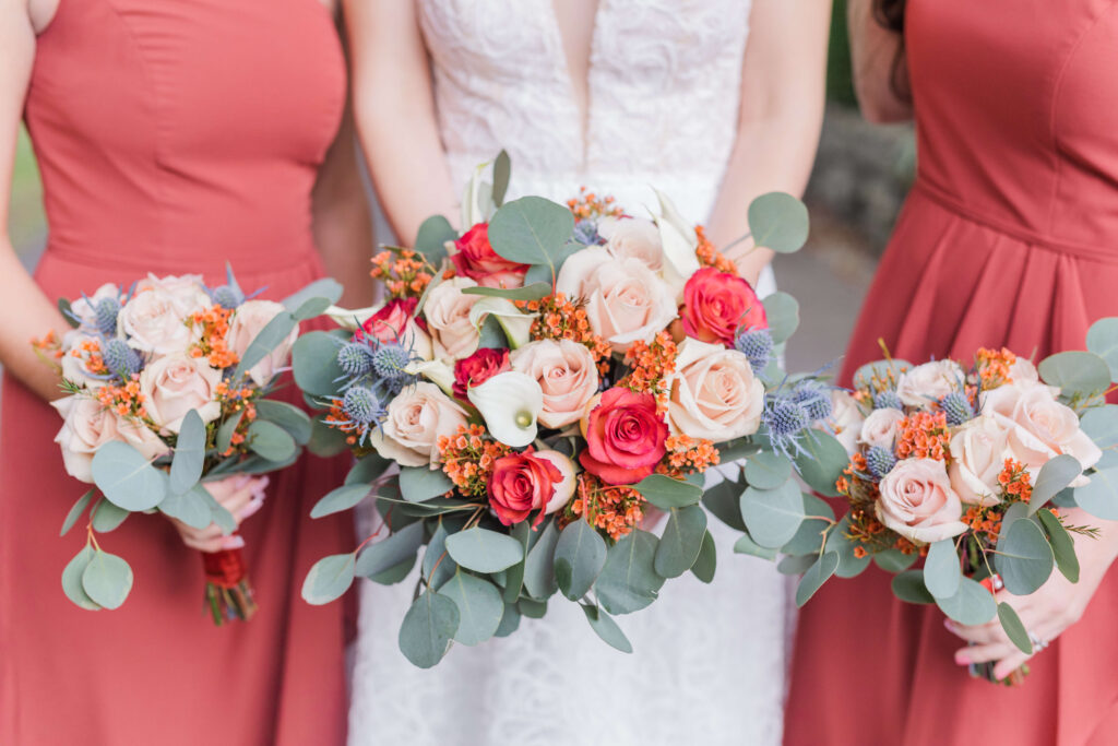 bride and bridesmaids holding bouquets at bel-wood country club