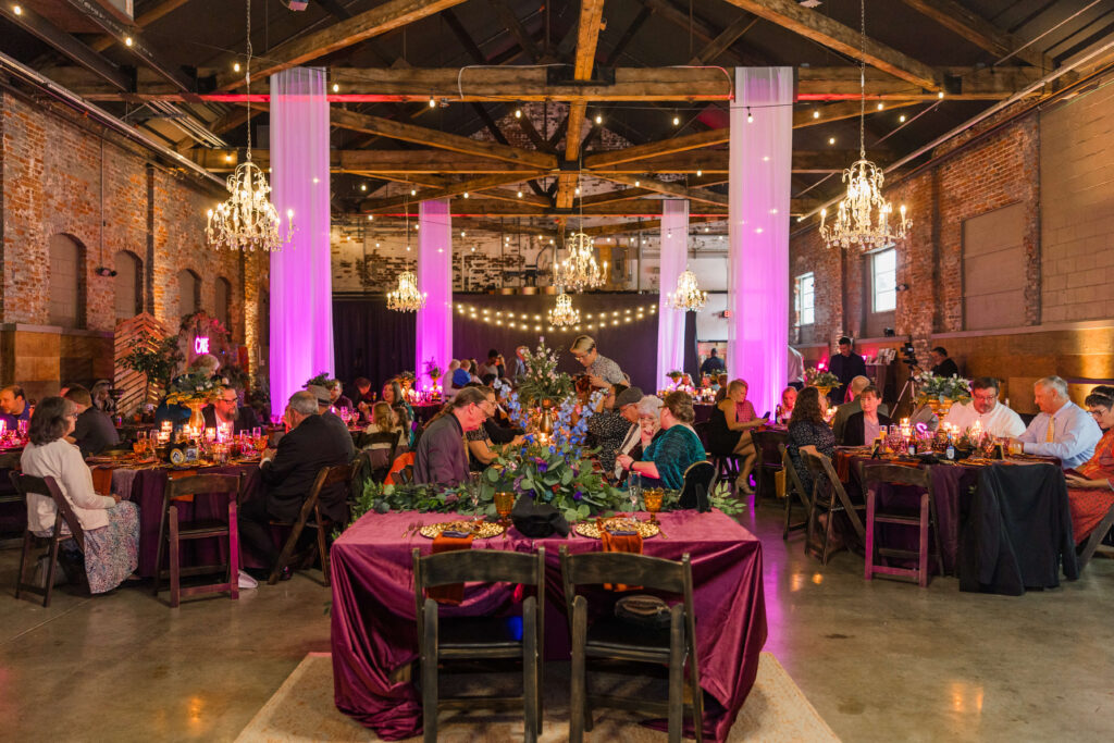 wedding reception at the brightside dayton. the colors are bright pink, berry, and green and the guests are seated enjoying dinner