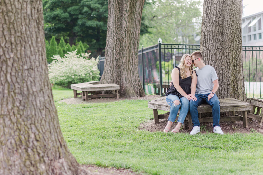 A couple sits on a park bench at their franklin conservatory wedding