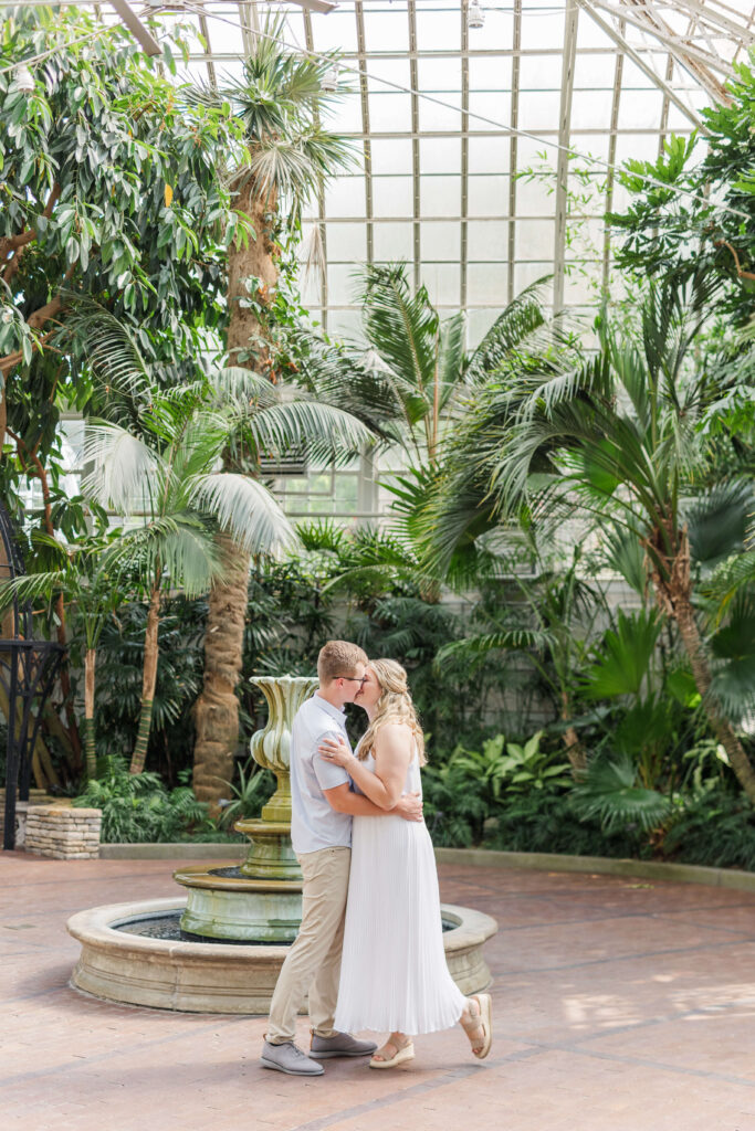 A man and woman kiss at their franklin conservatory wedding