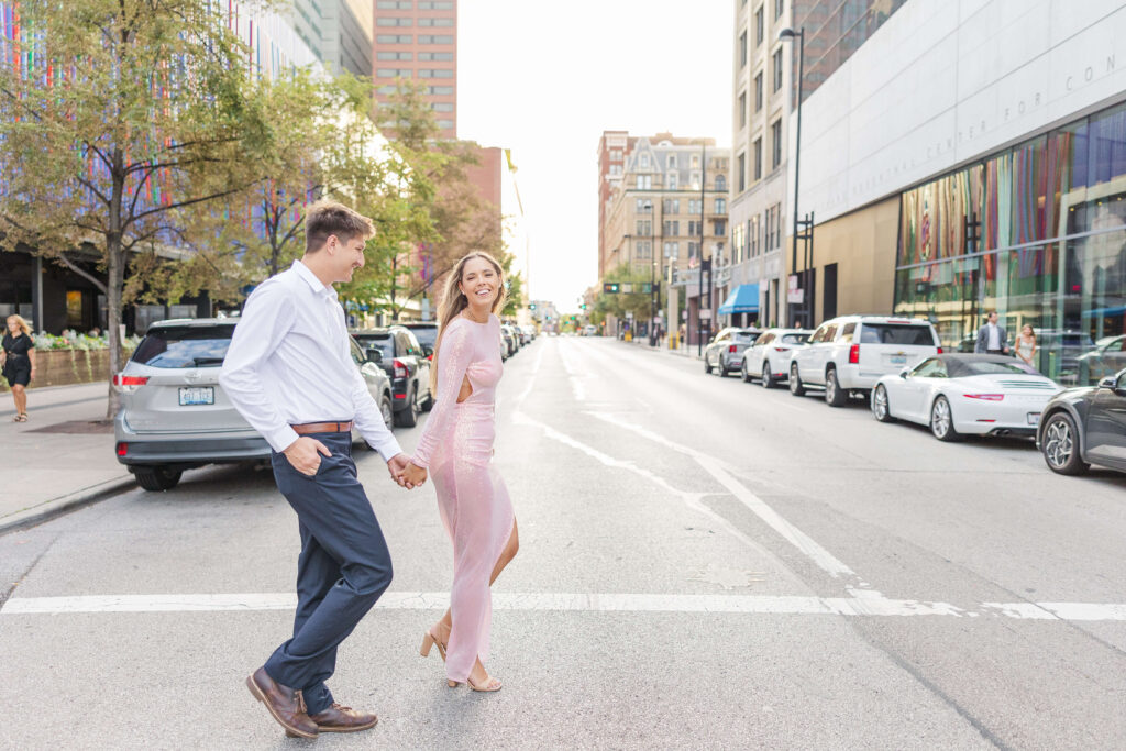 A couple walks in downtown cincinnati for engagement photos